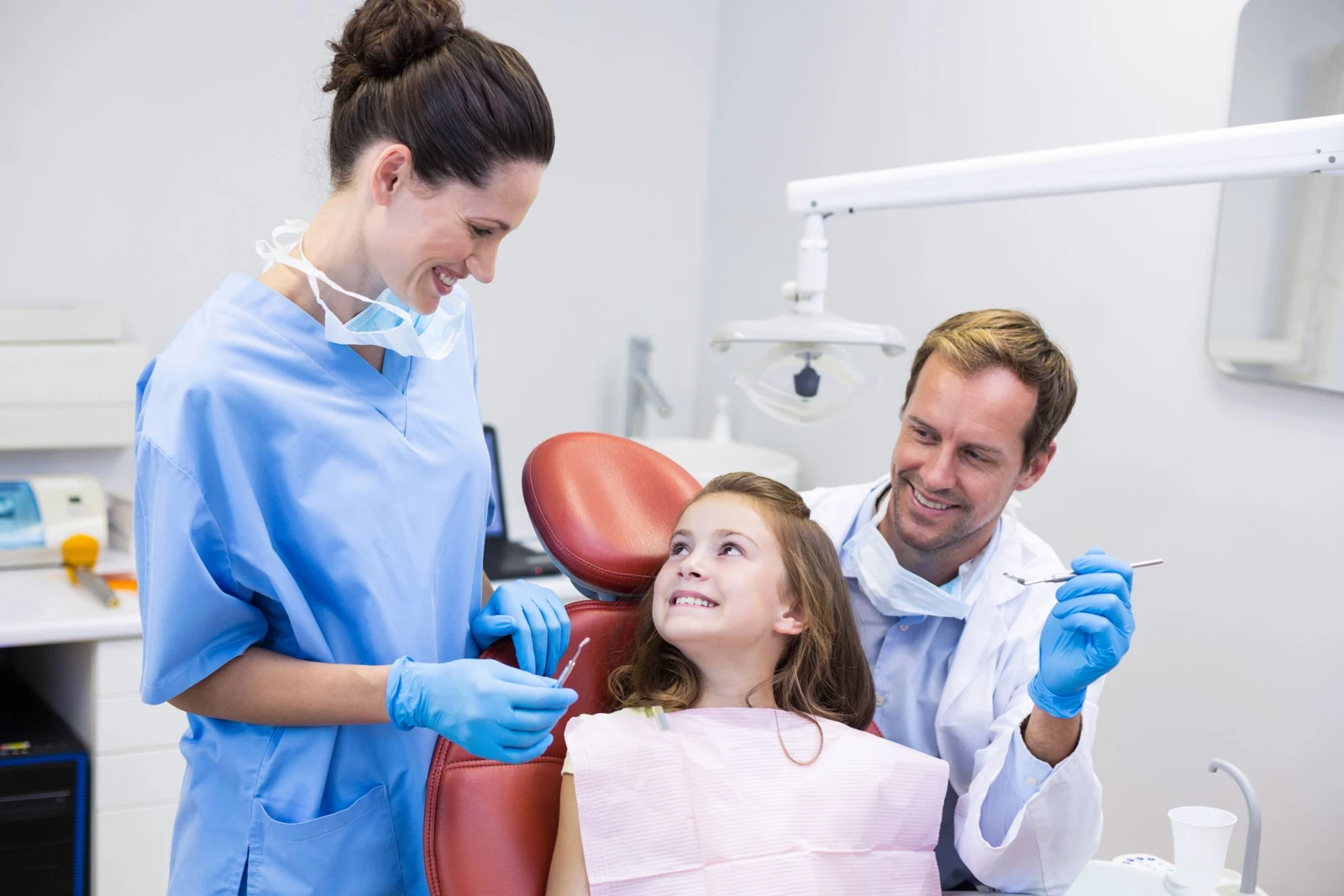 Illustrative photograph of dentists with a child and parent